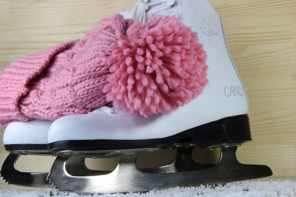 Pattini da ghiaccio con cappello di lana rosa