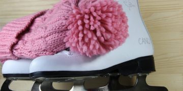 Pattini da ghiaccio con cappello di lana rosa