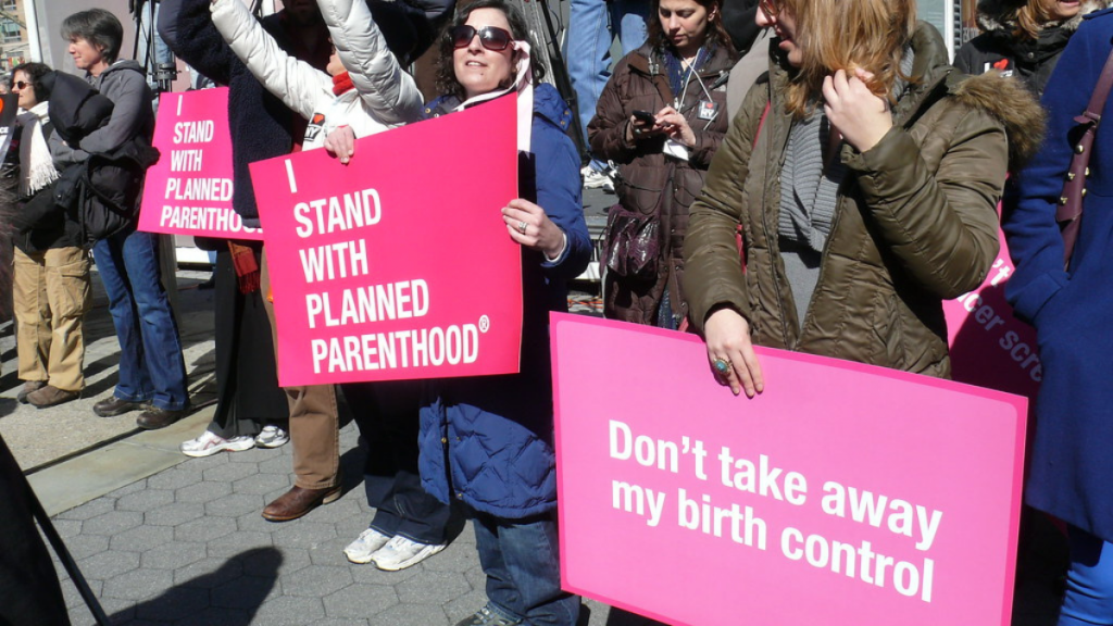 "I stand with Planned Parenthood" by ctrouper is licensed under CC BY 2.0.
