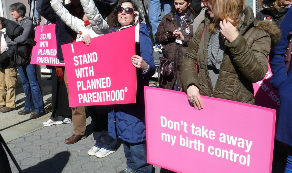 "I stand with Planned Parenthood" by ctrouper is licensed under CC BY 2.0.